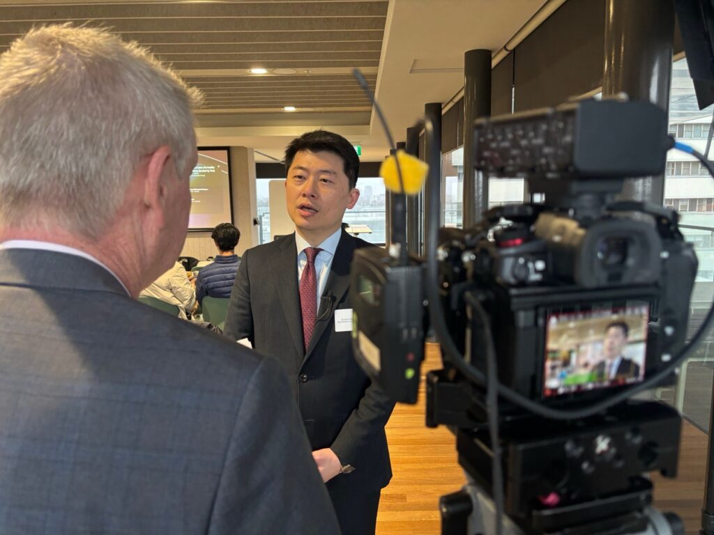 A spokesperson being interviewed on camera by a journalist